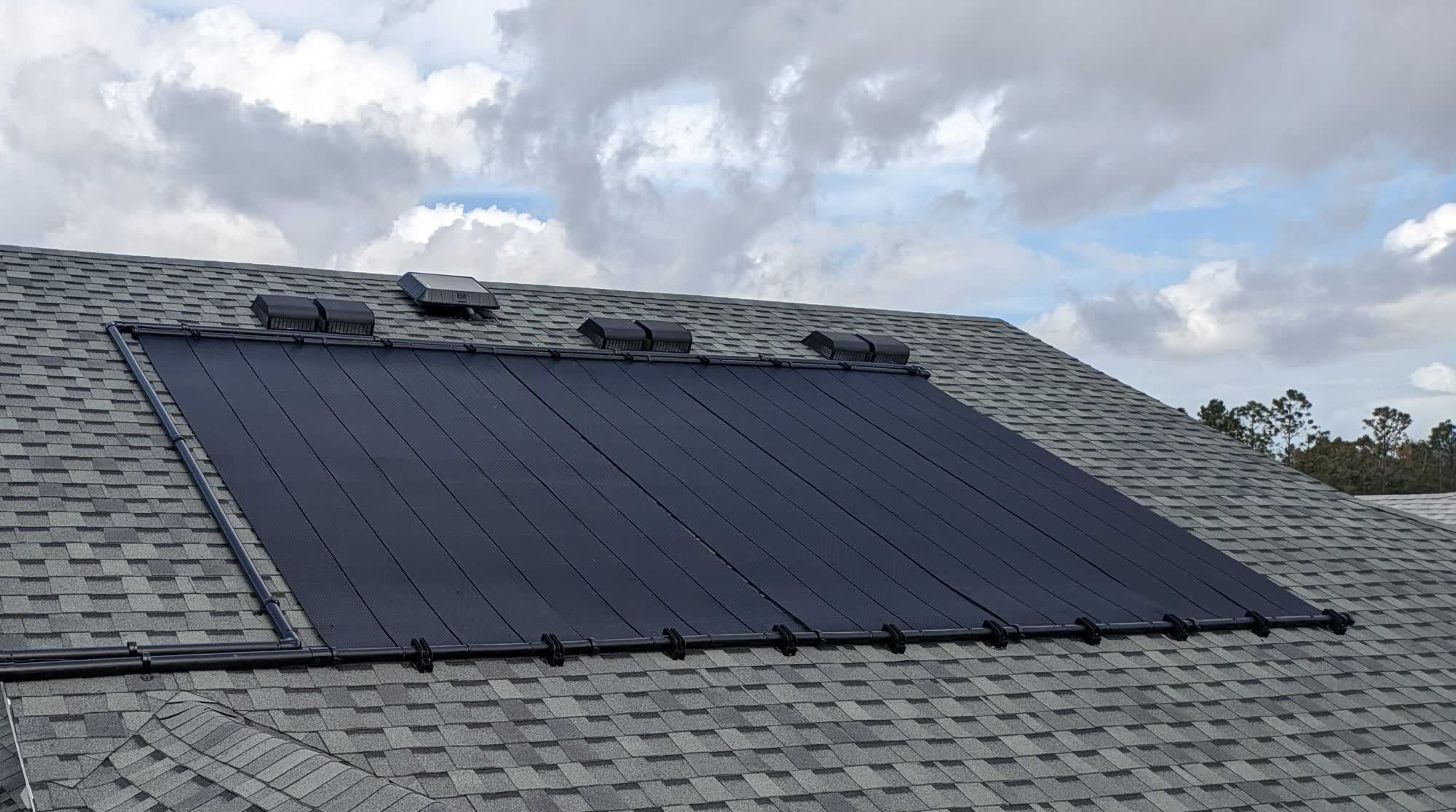 Solar pool heating collectors on a tile roof
