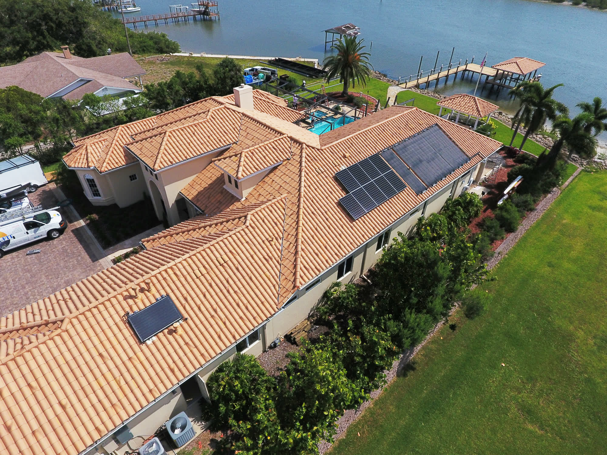 Aerial of a waterfront Edgewater home with rooftop solar