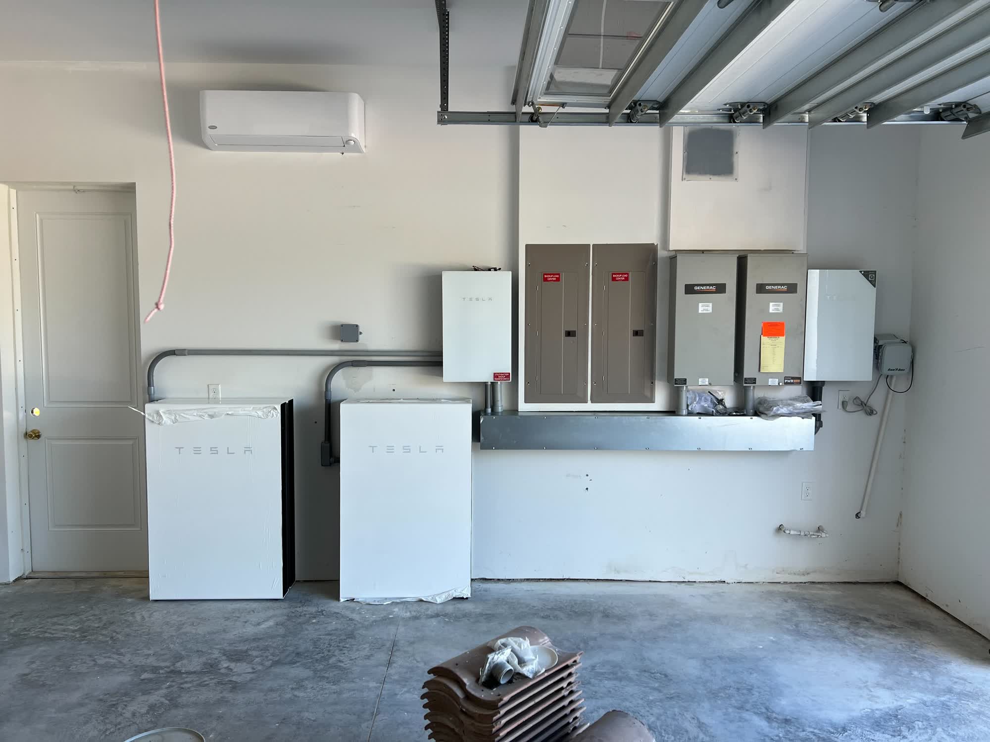 Two Tesla Powerwalls installed in a garage by Solar-Fit