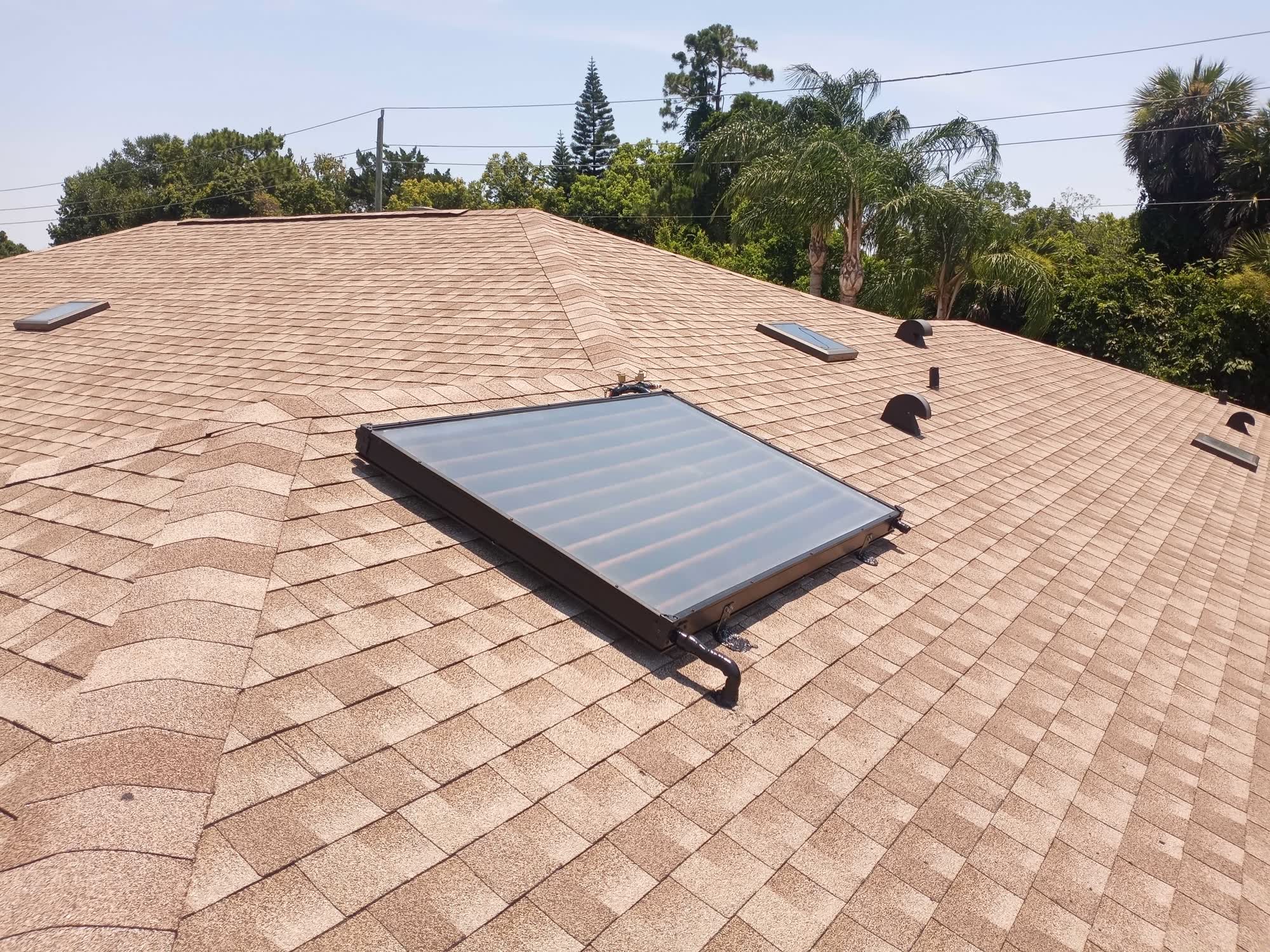 Solar water heating collector installed by Solar-Fit on a shingle roof